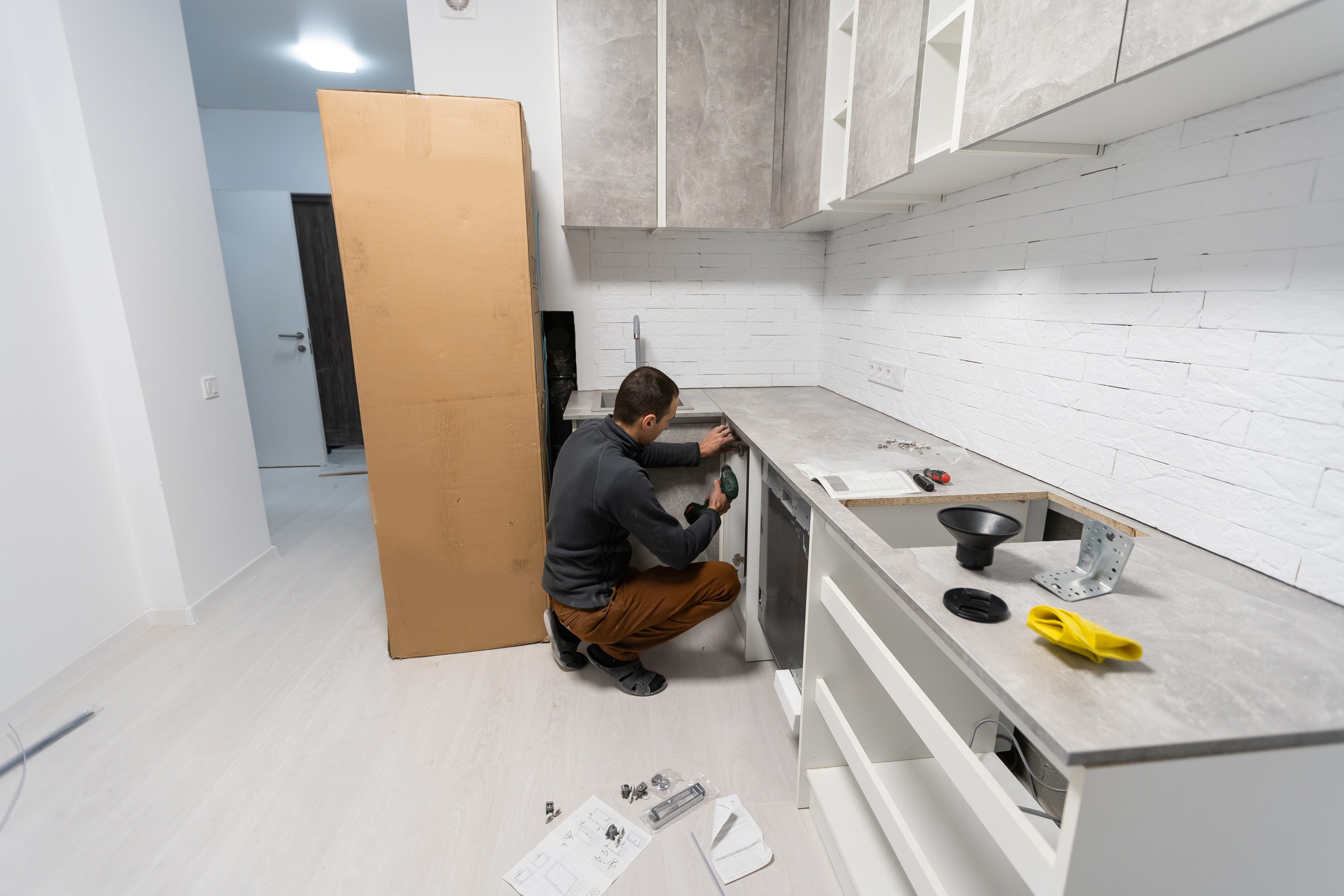 Installation hoses for dishwasher machine domestic connection plumbing pipes in kitchen